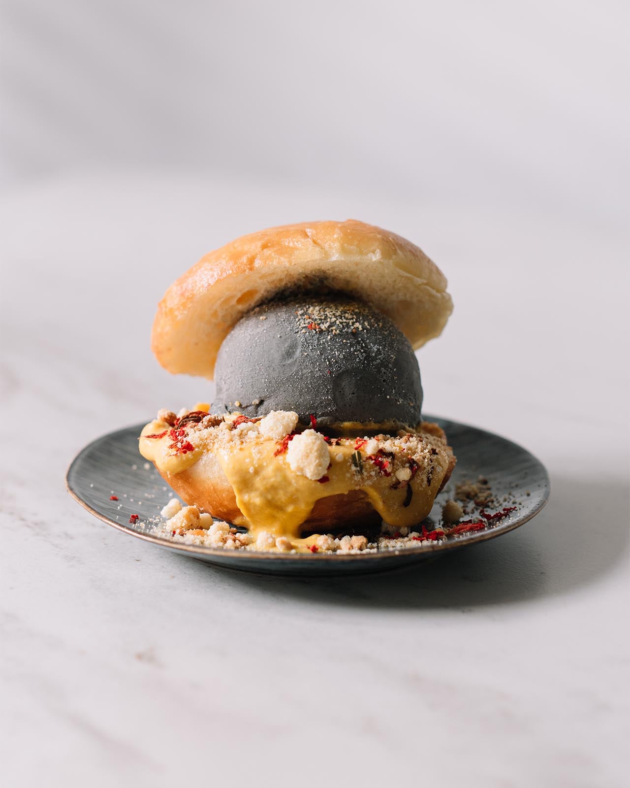 Black Sesame Ice Cream with Bread & Toppings on a Plate